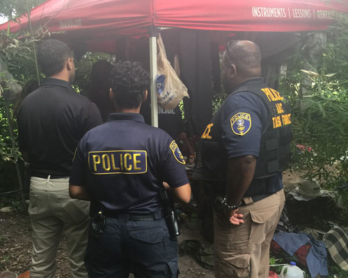 The Ƶ Police stand in front of a tent